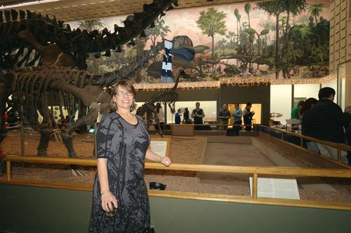 Vivian Irish at Peabody Museum in front of Main Hall dinosaurs