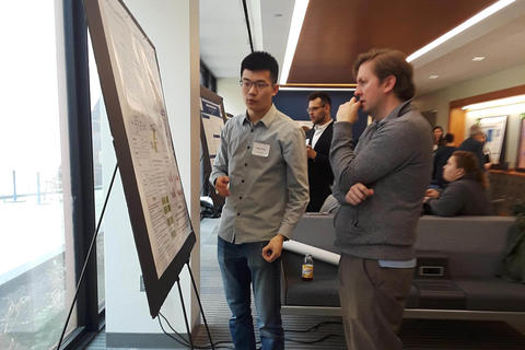 student explaining his poster