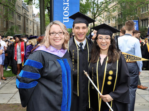 graduates with faculty advisor and pierson flag