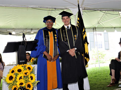 graduate and faculty posing for photo