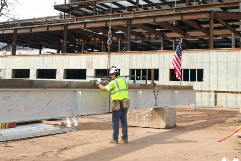 Construction worker preparing the beam for raising