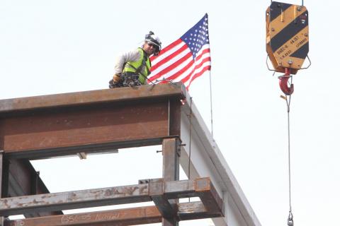 Construction worker fixing the beam into place