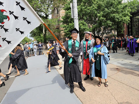 graduate carrying flag