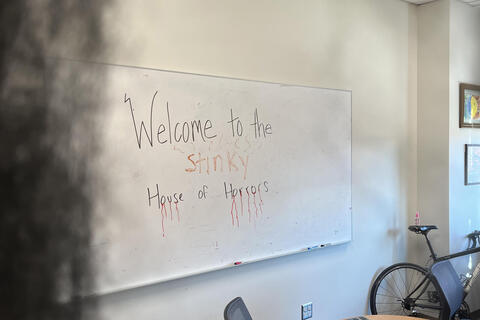 sign that reads welcome to the stinky house of horrors