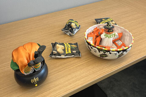 treats display candy chips and witch with her head in the bowl and feet poking out