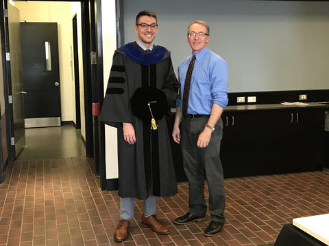 graduate posing with faculty advisor