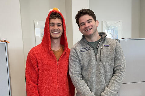 two people one dressed as elmo from sesame street
