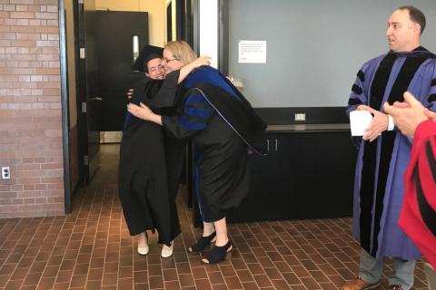 Valerie Horsley embraces Rachel Zwick after hooding. (Photo by Denise George)