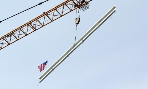 YSB signed beam being raised for the topping off