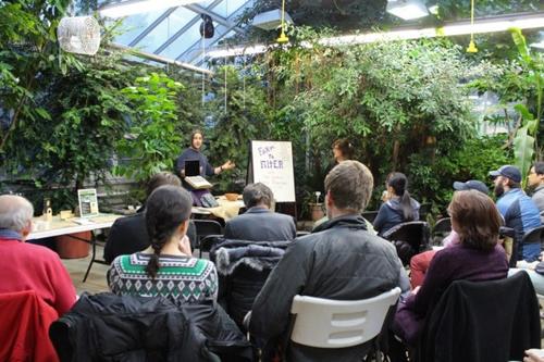 people attending a lecture in a greenhouse